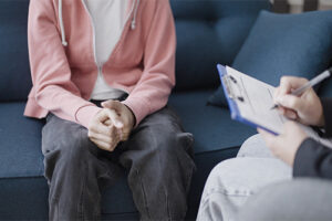 Person sits on couch and talks to therapist during intensive outpatient program