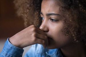 Teen sits and wonders if she needs trauma therapy