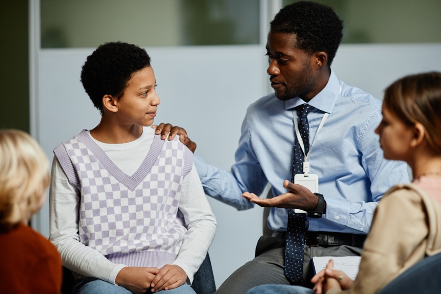 Teens participating in a dual diagnosis group therapy session.