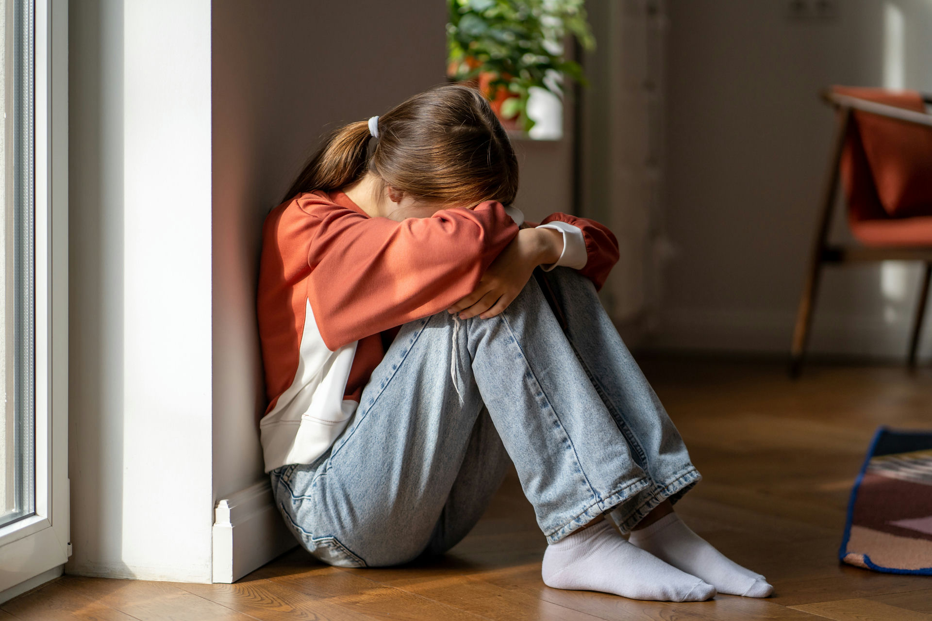 Teen with ADHD and addiction sitting alone, struggling with emotions
