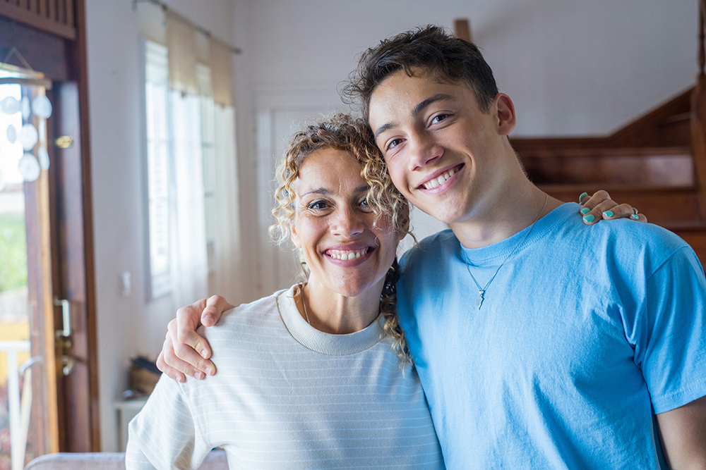 Parent and teen reconnecting after successful anxiety and addiction treatment.