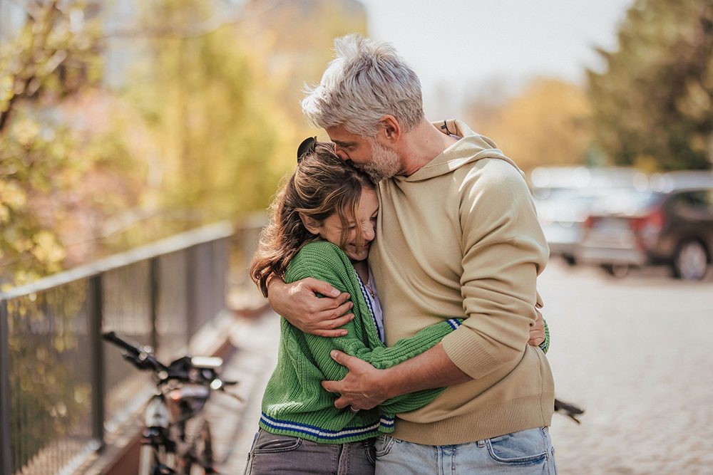 Teen and parent walking together, taking first steps toward dual diagnosis treatment.