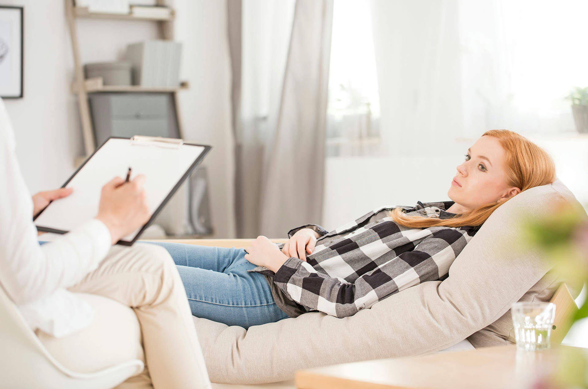 Teen and therapist talking in a supportive counseling session for anxiety and addiction treatment in Ohio.