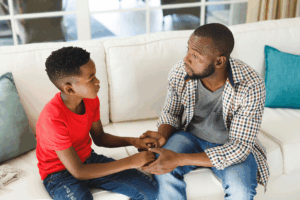 Parent explaining mental health to their child in a calm, supportive conversation.