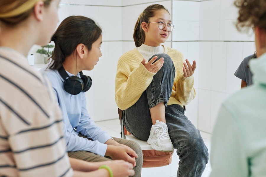 Adolescents participating in group therapy for bipolar disorder and substance abuse recovery.