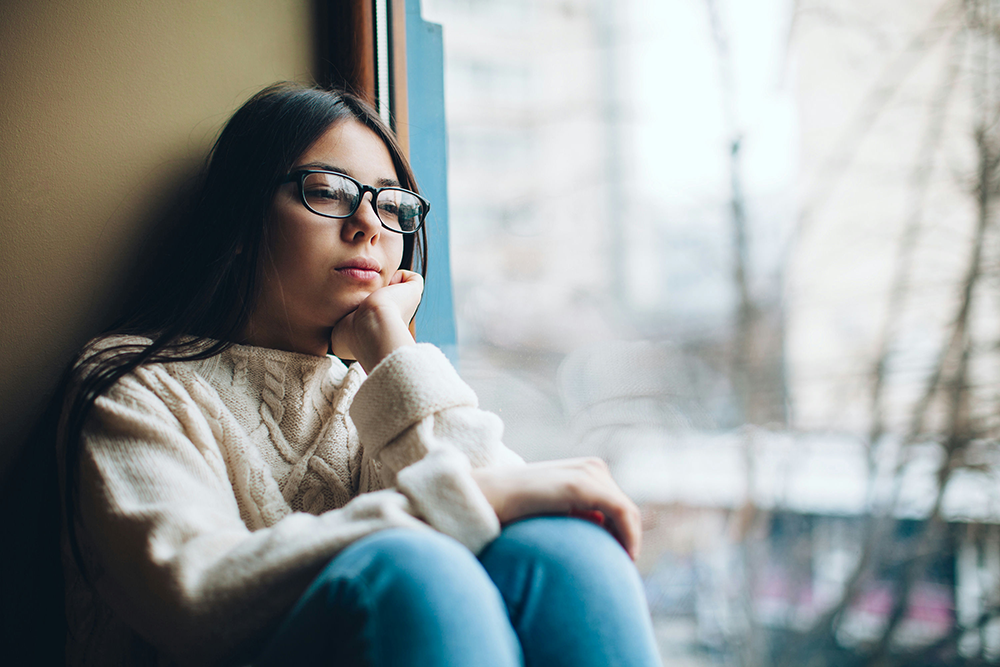 Teen reflecting on life, illustrating passive suicidal ideation and emotional distress.