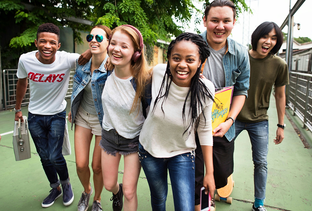 Diverse group of teens supporting each other, addressing identity-related pressures and belonging.