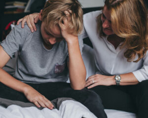 parent comforting an anxious child experiencing sudden behavior changes associated with PANS and PANDAS symptoms