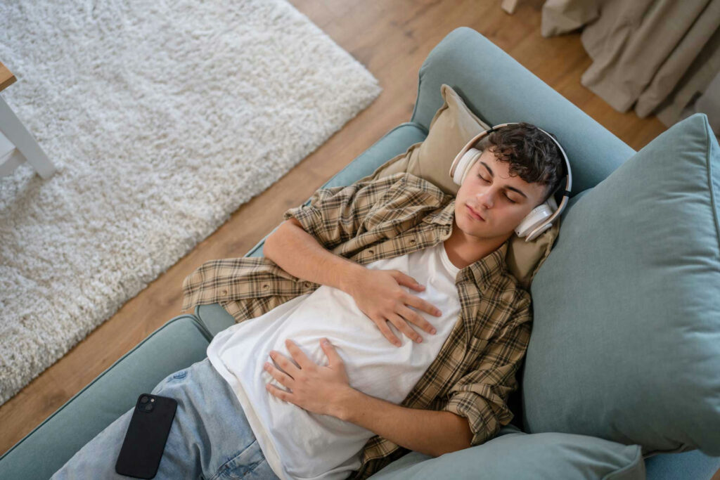 Teen practicing mindfulness or deep-breathing exercises in a quiet room, reflecting emotional regulation support.