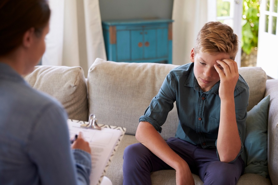 teenager speaking with therapist during a teen aftercare program session