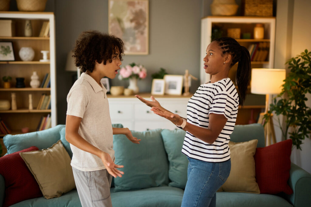 Teen arguing with parent at home while displaying oppositional defiant disorder behaviors