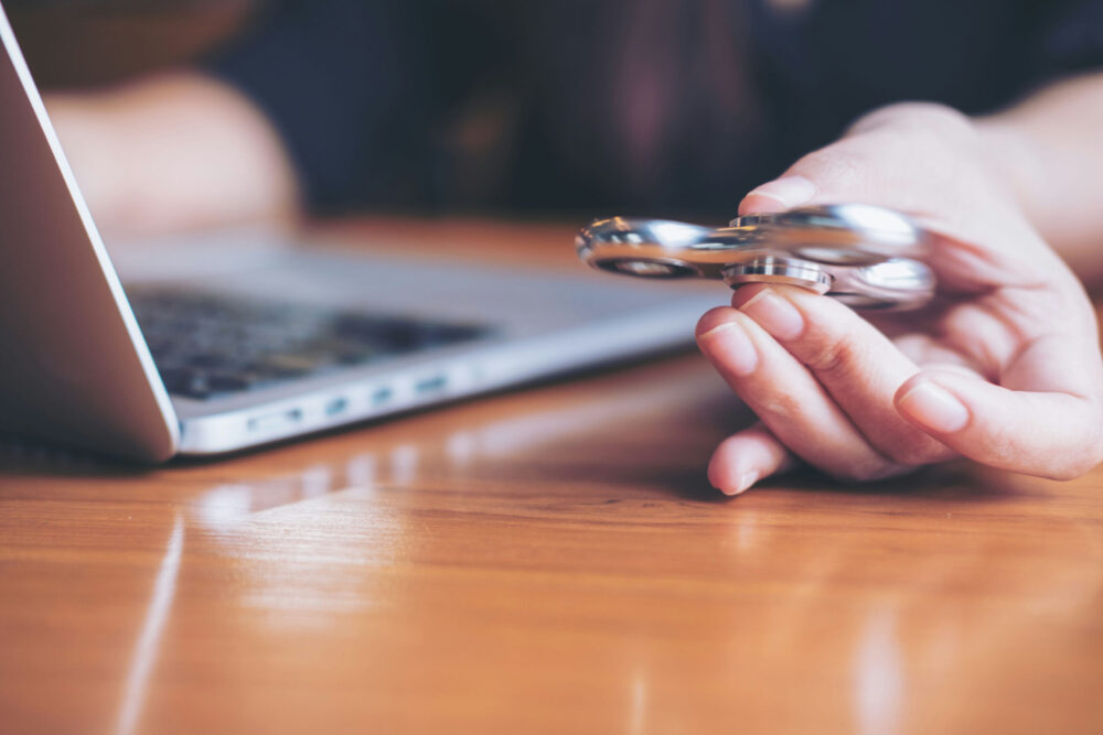 neurodivergent teen using a fidget tool to maintain focus