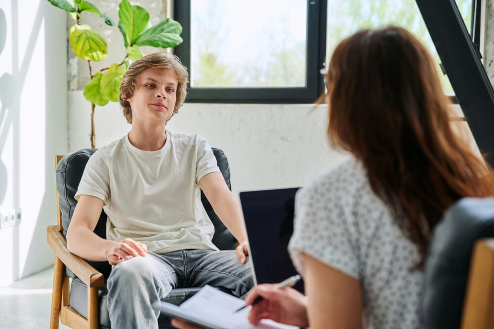 Adolescent discussing emotions and behavior with a licensed mental health professional