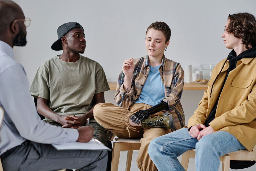 Group of teenagers having discussion during group therapy session in Columbus, Ohio.